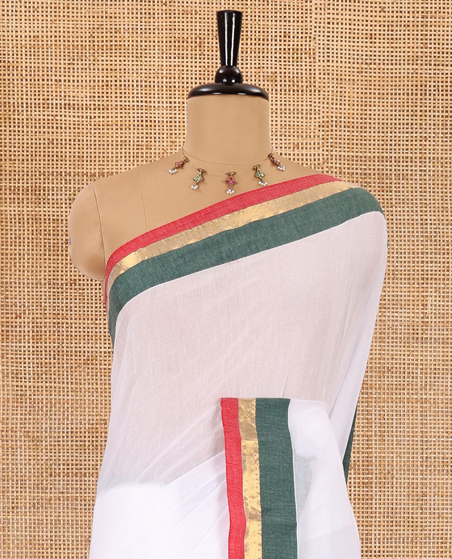 Half-white full-plain Khadi mul cotton saree, contrast red and green zari border, plain pallu, and a plain blouse