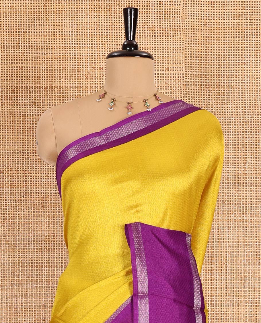 Yellow embossed moss chiffon saree, contrast traditional rettai pettu border, embossed pallu, and a contrast embossed blouse