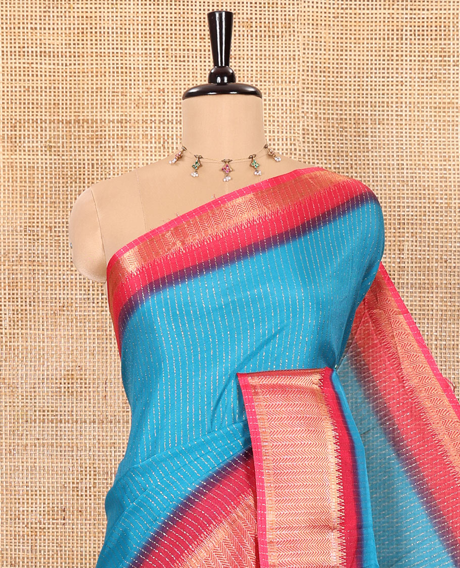 Blue Dola Silk Saree Gleamed up with Vertical Golden Stripes Running All Over Its Body, Complemented by a Contrast Traditional Zari Design Woven Border, Subtly Striped Pallu, and a Contrast Buttas Woven Blouse