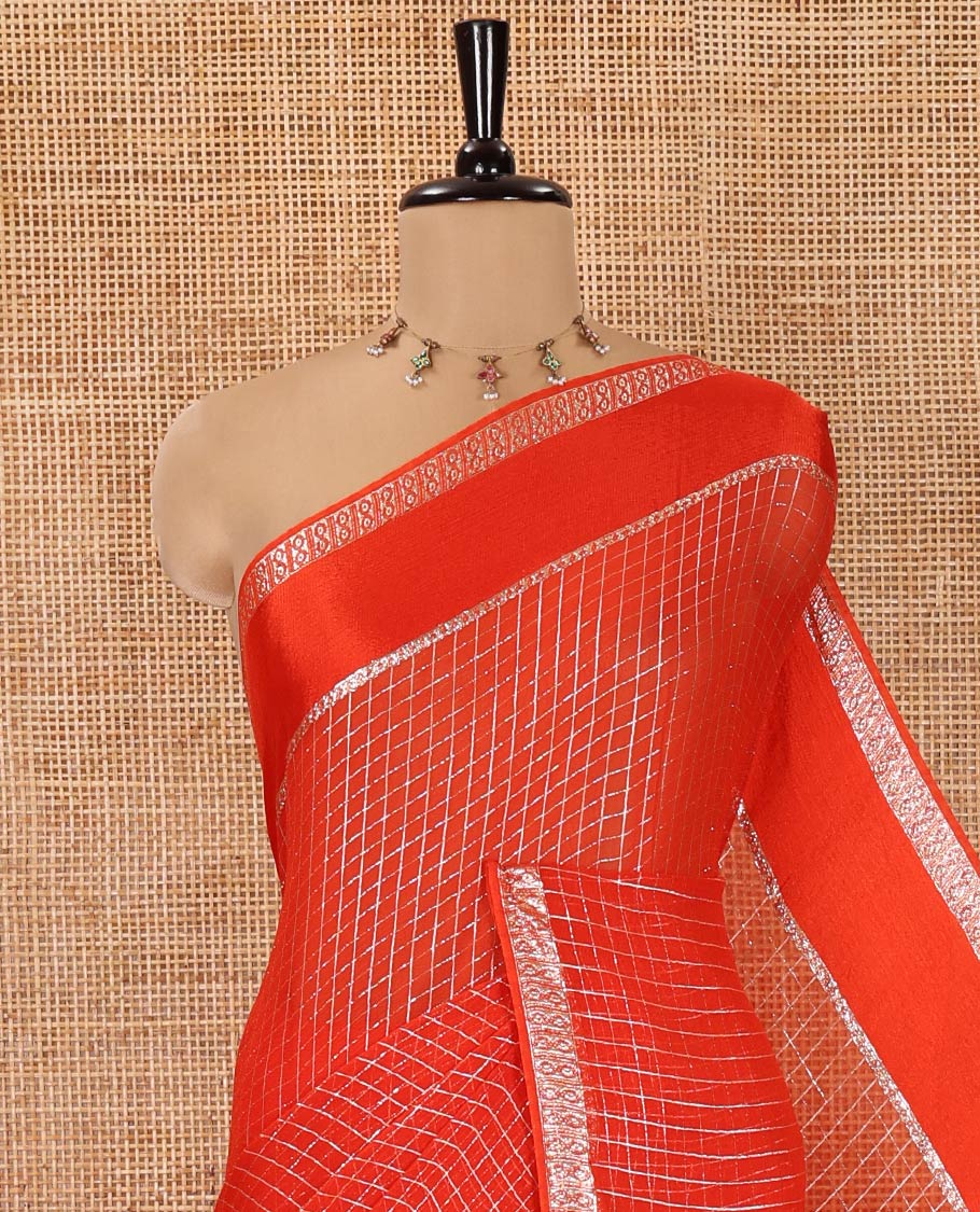 Scintillating Orange Viscose Georgette Saree Gleamed Up with Checked Design on Its Body, Highlighted by a Double-Pet Border, Zari Checked Design Pallu, and Paired with a Matching Blouse