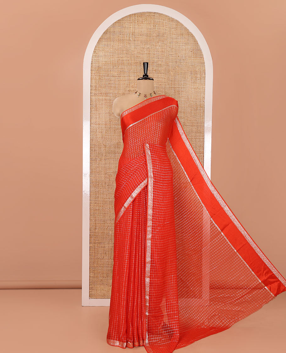 Scintillating Orange Viscose Georgette Saree Gleamed Up with Checked Design on Its Body, Highlighted by a Double-Pet Border, Zari Checked Design Pallu, and Paired with a Matching Blouse