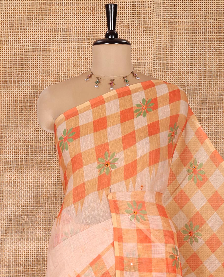 Chikku and Orange Linen Cotton Saree, Elevated with Mirror Work On Its Body, Complemented by Contrast Temple Checked Border of Floral Print and Mirror Work, Pallu Mirrors the Same Design and Paired with a Contrast Blouse
