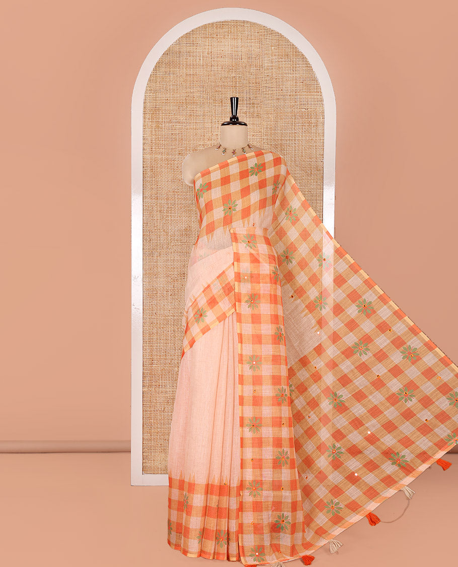 Chikku and Orange Linen Cotton Saree, Elevated with Mirror Work On Its Body, Complemented by Contrast Temple Checked Border of Floral Print and Mirror Work, Pallu Mirrors the Same Design and Paired with a Contrast Blouse