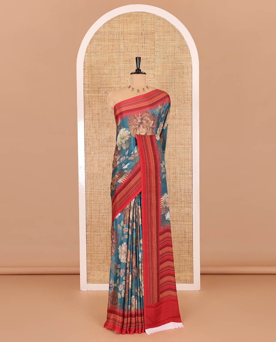 Teal blue floral printed Italian crepe saree, contrast temple printed border, striped pallu, and a printed bordered blouse