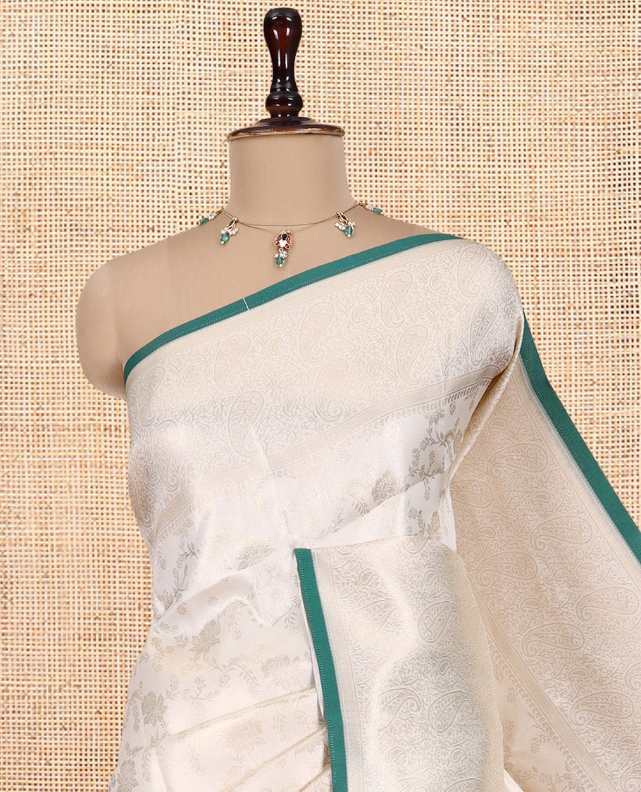 Off-White-Leaf Green Semi-Silk Saree, Adorned with Floral Jacquard Design, a Zari Paisley Border, and a Contrast Blouse
