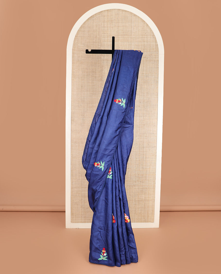 Borderless ink blue base tussar saree with kaleidoscopic-colored thread floral embroidery motifs