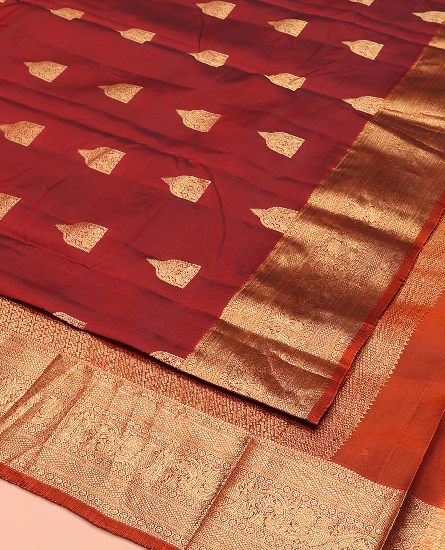 Maroon Vasundhara Lite-Silk Mix Saree, Detailed with Zari Buttas All Over Its Body, Highlighted by a Zari Border of Rekku, Kamalam, Kuyil Kann, Yaanai, and Mayil Designs, Grand Pallu of Jaal Designs, and Paired with a Contrast Blouse