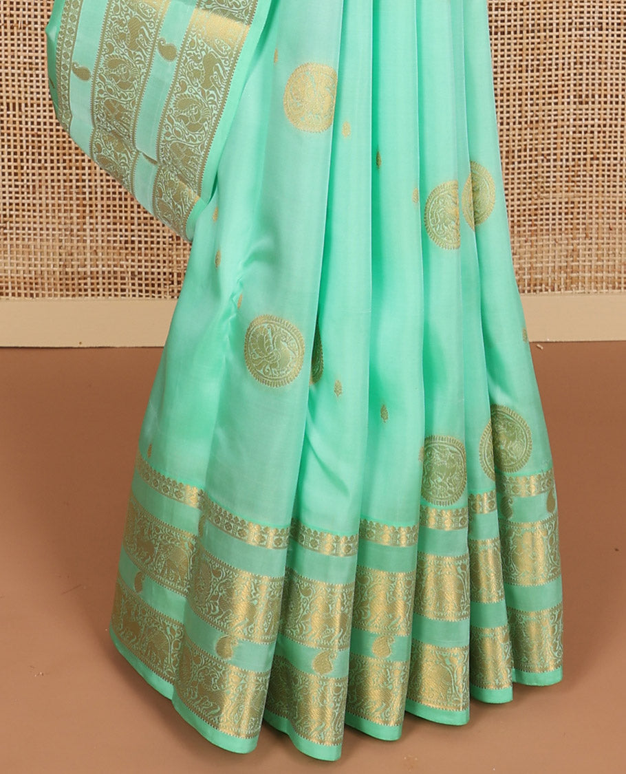 Sea green buttas vasundhara elite silk saree with self zari design border & floral design pallu
