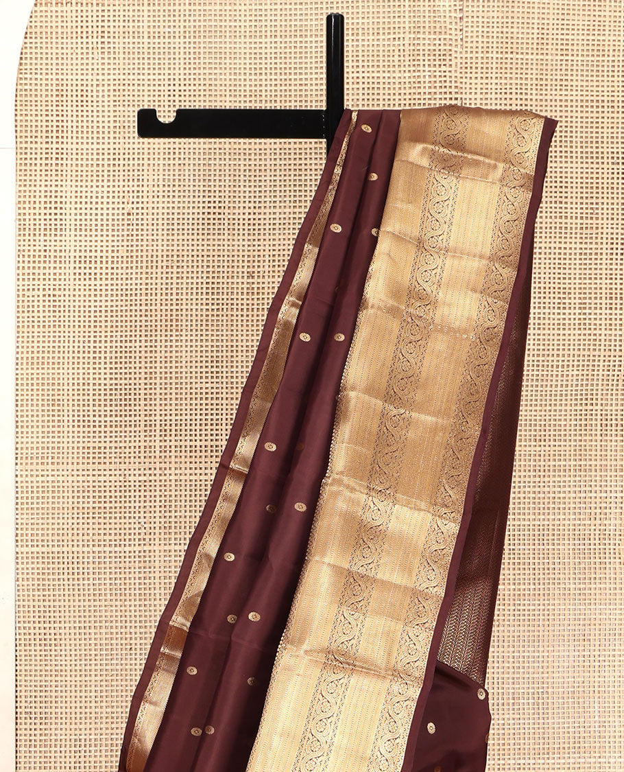 Brown Vasundhara Lite Silk Mix Saree, Decked Up with Zari Buttas All Over Its Body, Highlighted by a Zari Border of Salngai, Muthu, Dhavana Kodi, and Mayil Kann Designs, Pallu of Leaf Vine Designs, and Paired with a Matching Blouse