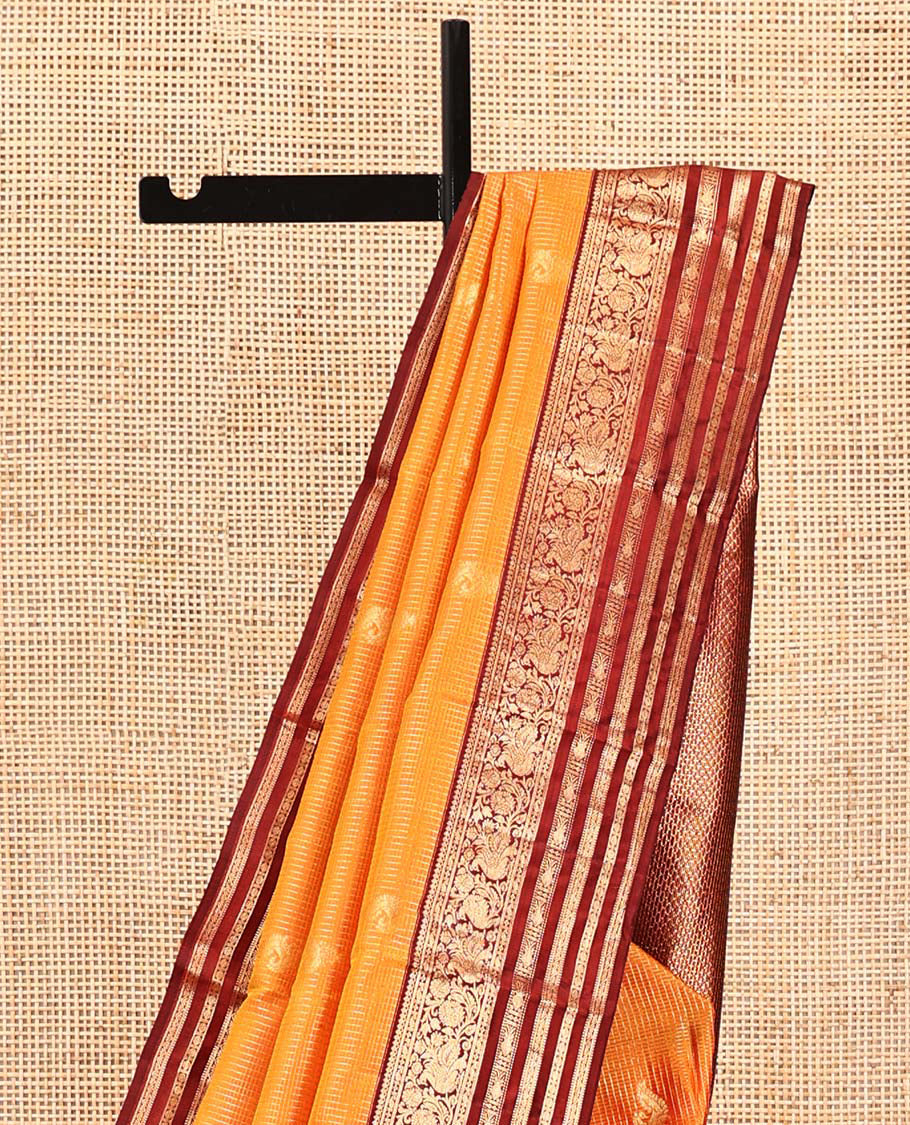 Orange Vasundhara Silk Saree, Masterfully Woven with Zari Buttas and Checks All Over Its Body, Complemented by a Contrast Border of Thilakam Mokku, Manga, Mayil, and Meen Designs, Grand Pallu, and Paired with a Contrast Blouse