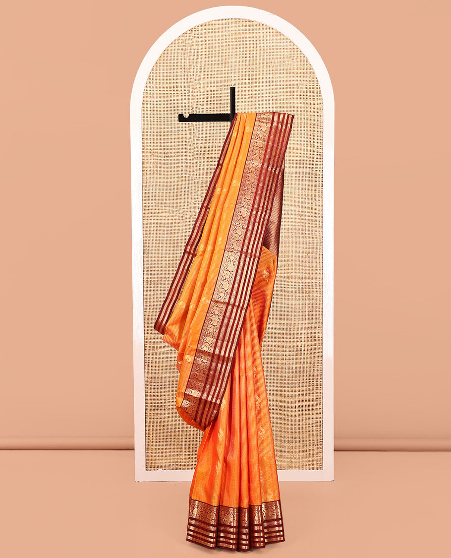 Orange Vasundhara Silk Saree, Masterfully Woven with Zari Buttas and Checks All Over Its Body, Complemented by a Contrast Border of Thilakam Mokku, Manga, Mayil, and Meen Designs, Grand Pallu, and Paired with a Contrast Blouse