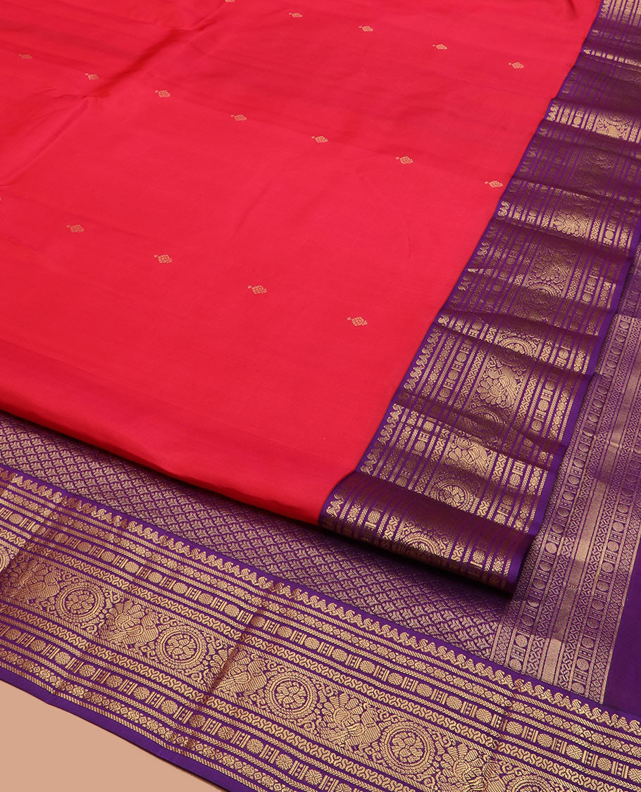 Red Vasundhara Silk Saree Adorned with Zari Buttas, Complemented by a Contrast Border of Thilakam Mokku, Banaras, Rudraksham, Kathir, Cross Neli, and Anna Chakram Designs, Pallu Decked Up with Jaal Designs, and Paired with a Contrast Blouse