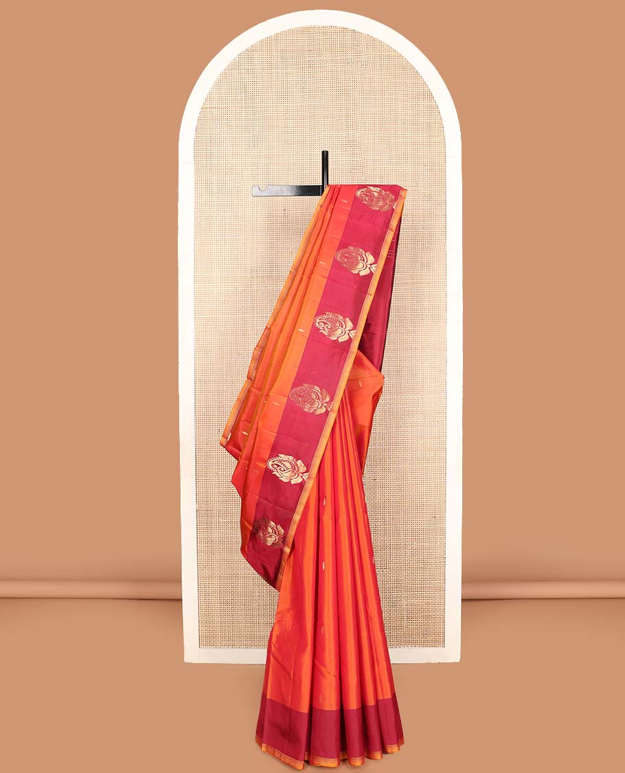 Orange zari buttas Kanchipuram silk saree, contrast border of manga designs, and pallu of Kumbam designs