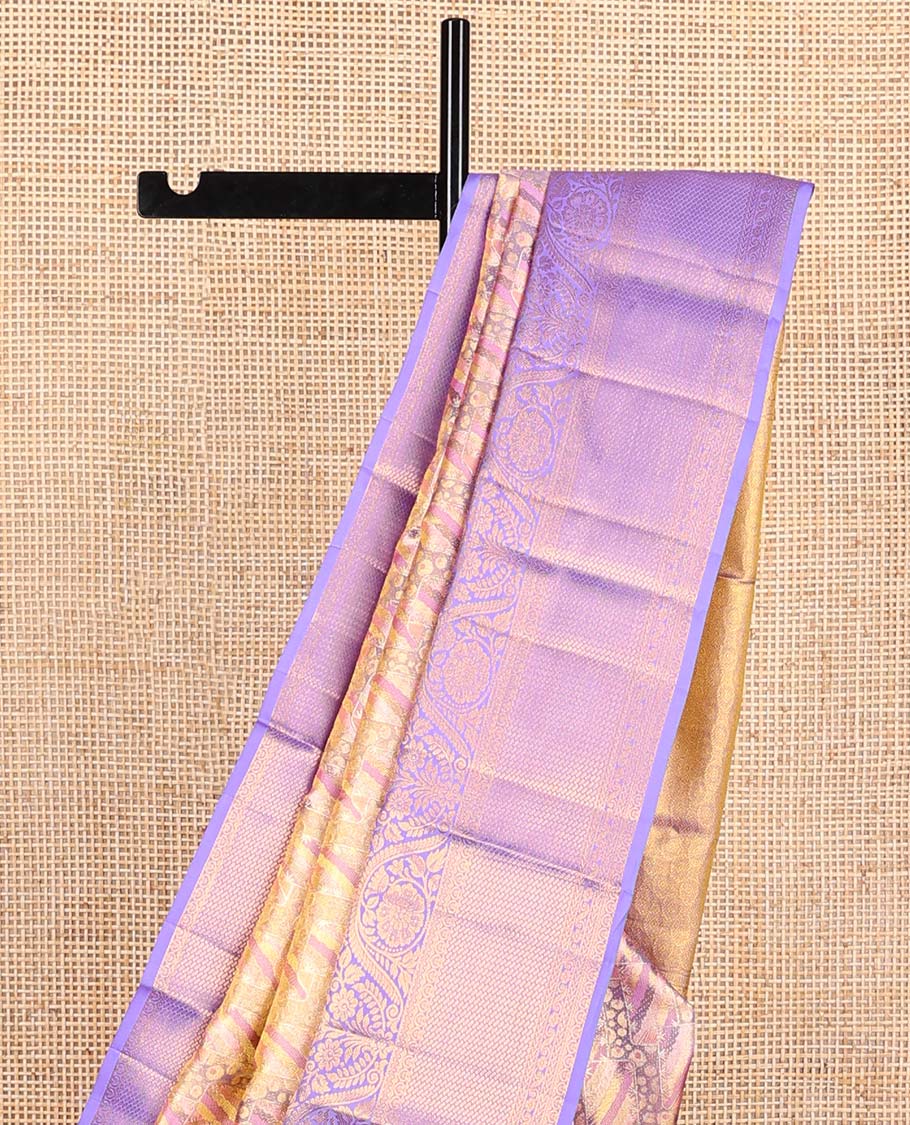 Pink Kanchipuram Tissue Silk Saree, Mesmerized with Jacquard Design on Its Body, Complemented by a Contrast Border of Thilakam, and Dhavana Kodi Designs, Pallu Steeped with Poun Designs, and Paired with a Contrast Blouse