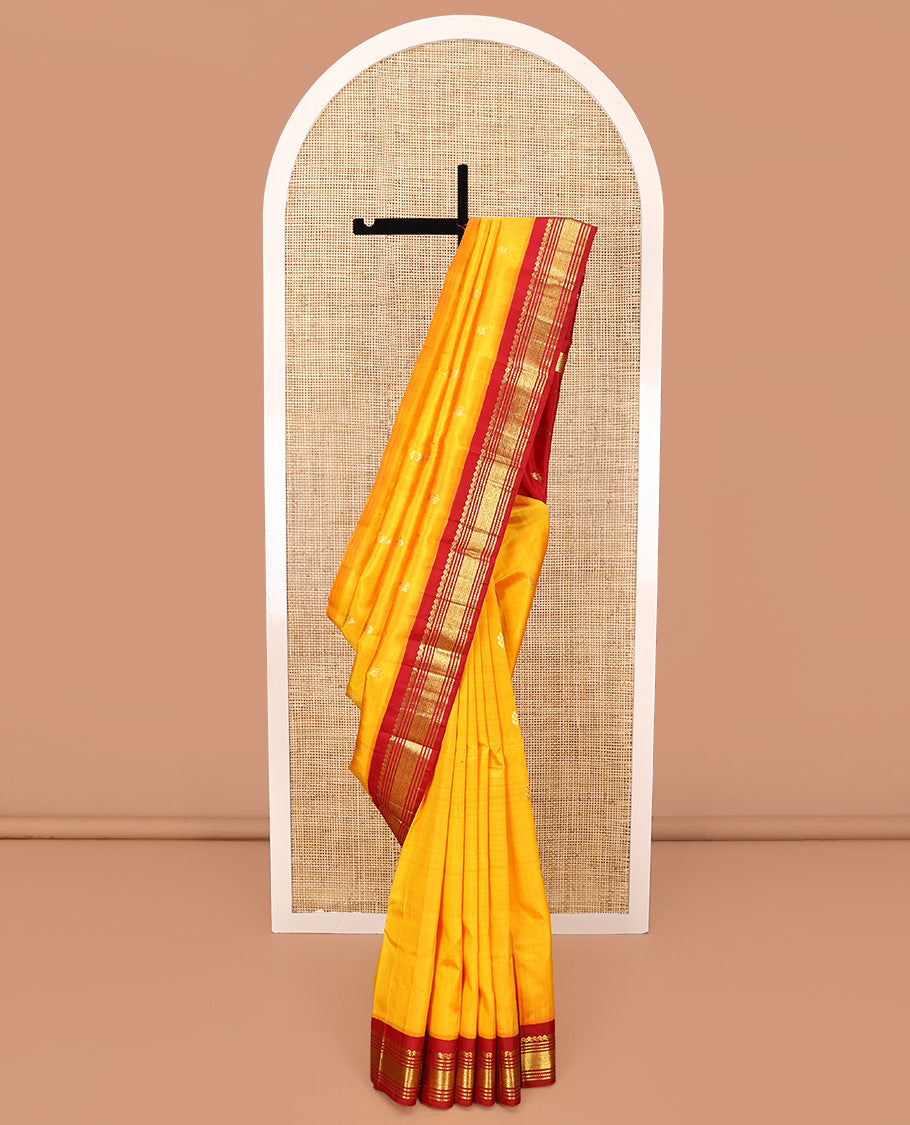 Yellow Kanchipuram Silk Saree, Woven with Zari Buttas All Over Its Body, Complemented by a Contrast One-Sided Korvai Border of Salngai, Banaras, Muthu, and Mayil Kann Designs, Pallu of Zari Designs, and Comes Without a Blouse