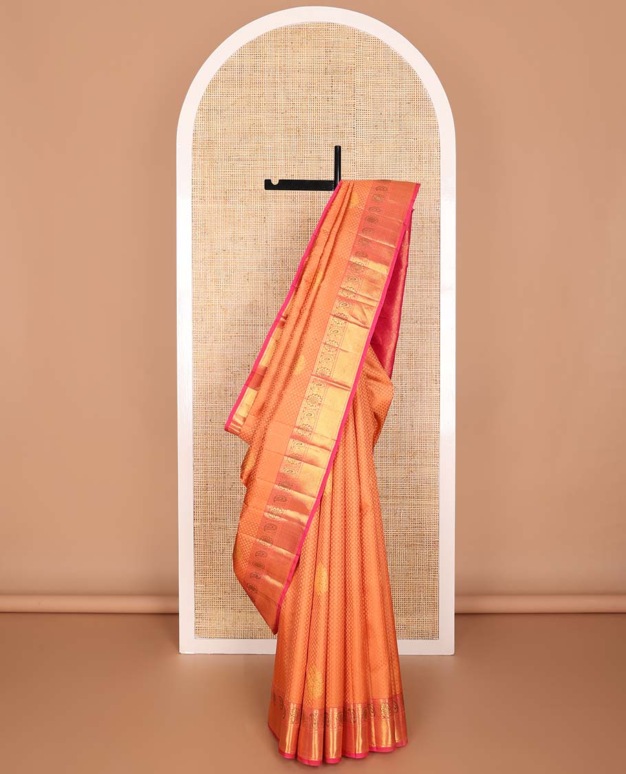 Orange floral design silk saree with contrast border of thilakam mokku, paun, manga design & argyle design pallu