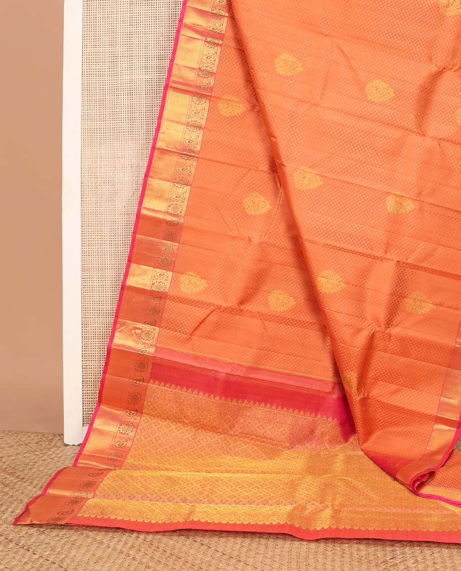 Orange floral design silk saree with contrast border of thilakam mokku, paun, manga design & argyle design pallu