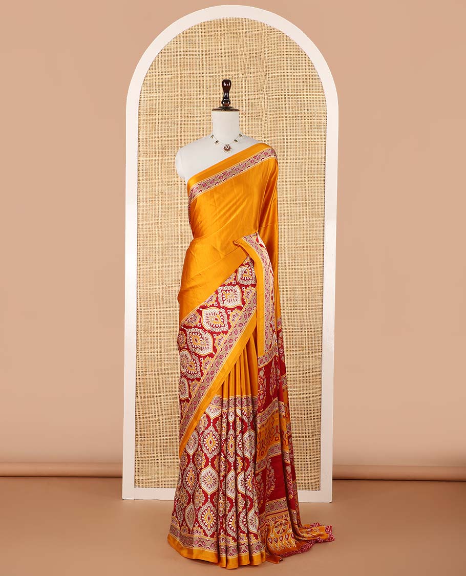 Mango yellow half-&-half style modal satin saree features floral & geometric Ajrakh printed contrast border & pallu