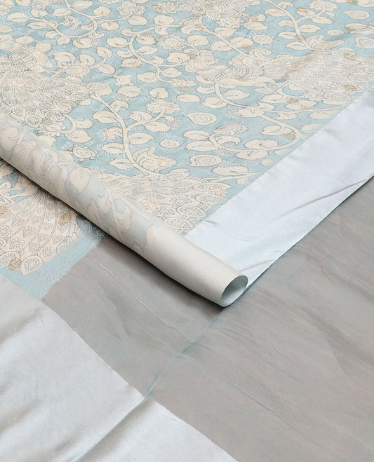 Blue kalamkari-style floral vine & peacock printed tussar saree with zari buttas, plain border & plain pallu