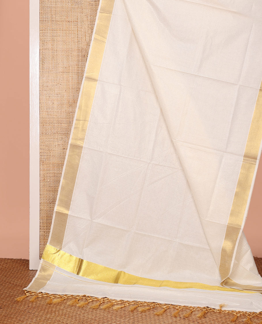 Cream Kerala Cotton Saree, Sparsely Decked Up with Stripes All Over Its Body, Bavanji Border, Pallu Mirrors the Same Stripes, and Paired with a Matching Blouse