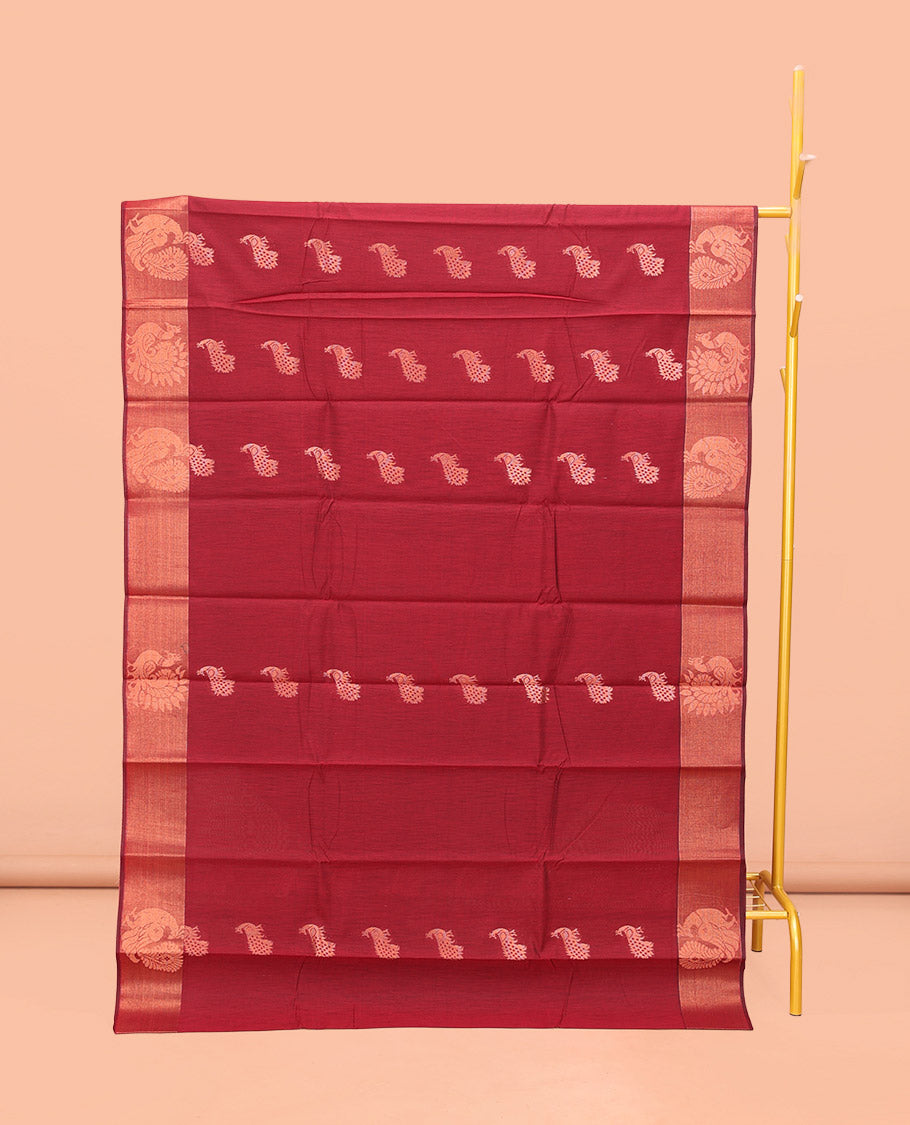 Maroon Semi-Silk Cotton Saree, Ornamented with Peacock Buttas All Over Its Body, Highlighted by a Zari Border of Peacock Designs, Pallu Steeped with Peacock Zari Motifs, and Paired with a Matching Blouse