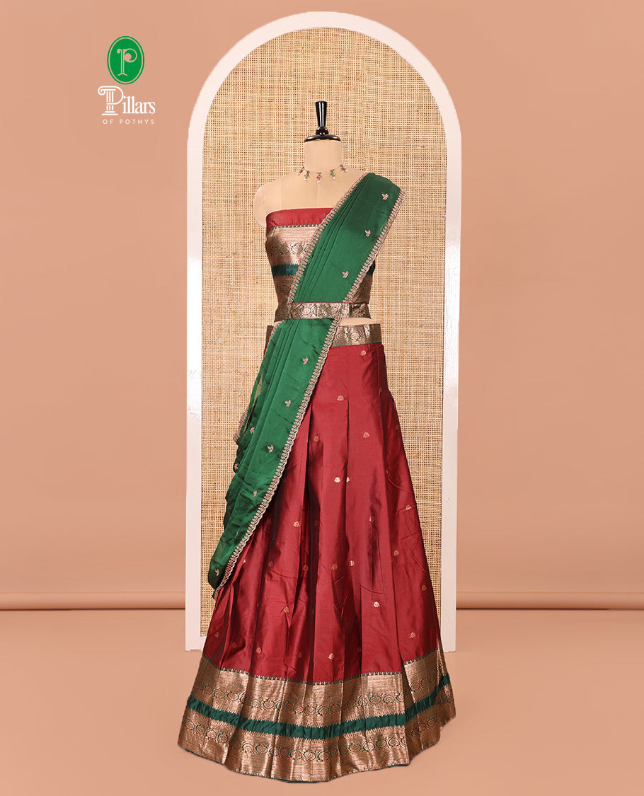 Maroon and Green Semi-Banarasi Half-Saree Featuring Zari Buttas Skirt, Complemented by Contrast Rettai Pettu, Traditional Border of Floral Creeper Designs, Paired with a Matching Blouse, and a Satin Georgette Embroidered Scallop Dhavani