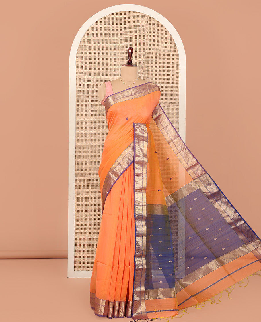 Orange Maheshwari Cotton Saree, Delicately Woven with Thread Buttas All Over Its Body, Complemented by Contrast Traditional Zari Design Border, Pallu Steeped with Zari Buttas, and Paired with a Contrast Blouse
