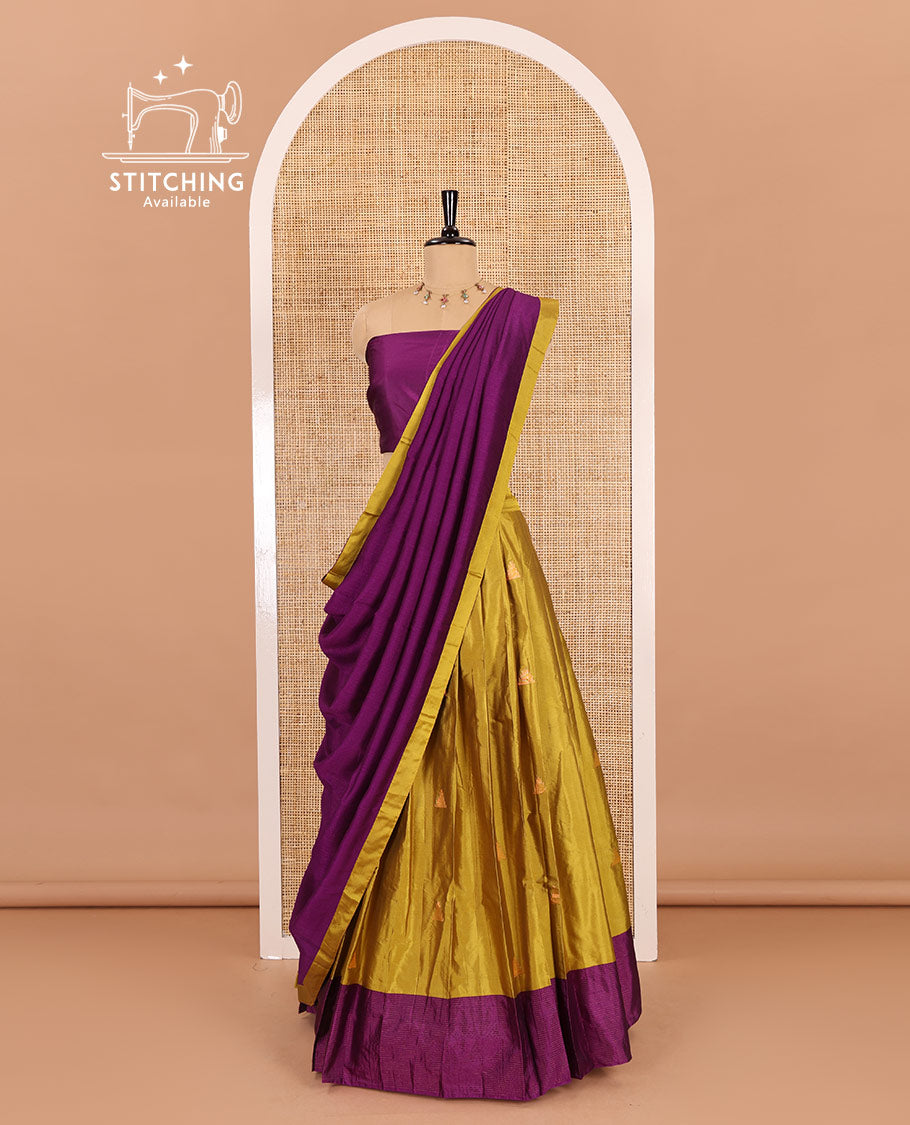Yellow and pink half-saree, buttas with traditional zari bordered taffeta silk skirt, a plain blouse, and a contrast vichitra silk dhavani
