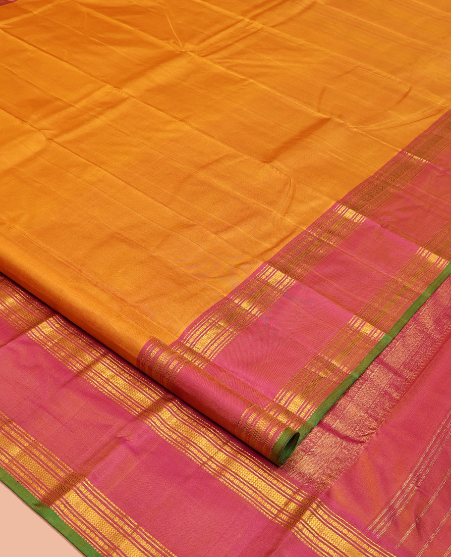 Orange Plain Kanchipuram Silk Saree, Complemented by Contrast Rettai Pettu Border of Rekku, Rudraksham, and Vanki Designs, Pallu of Traditional Zari Designs, and Paired with a Contrast Blouse