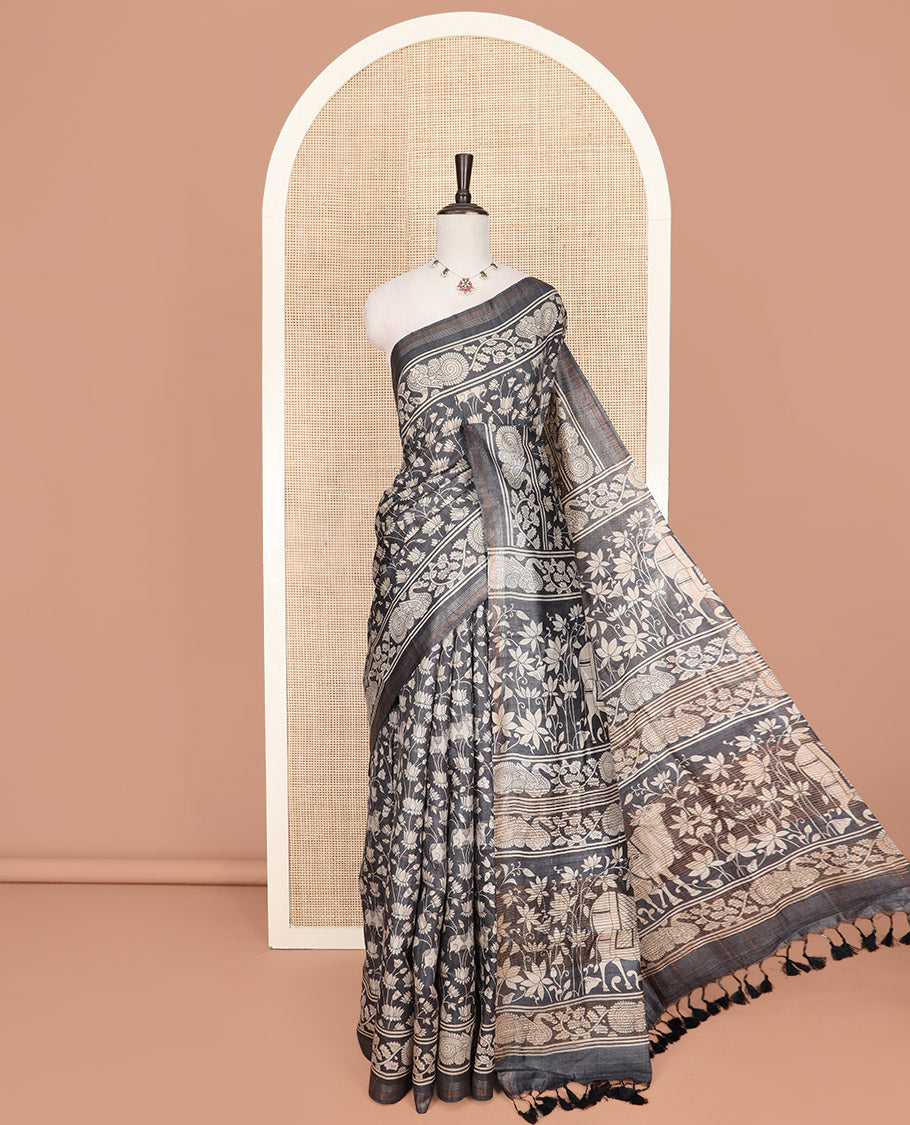Black Tussar Saree Artfully Printed with Pichwai Cow and Lotus Motifs All Over Its Body, Subtly Made Self-Border of Kalamkari Floral-Peacock Print, Pallu Mirroring Pichwai Cow-Lotus Print, and Paired with a Plain Blouse
