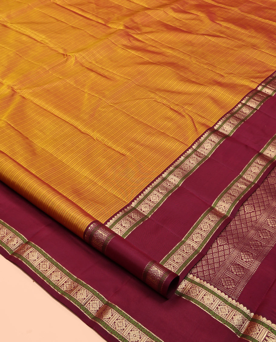 Mustard Striped Kanchipuram Silk Saree, a Contrast Rettai Pettu Border of Thilakam, Rudraksham, and Zari Designs, Intricate Pallu, and a Contrast Blouse