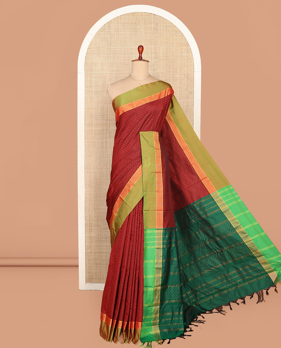 Maroon Aarani Silk Saree, Detailed with Zari Buttas on Its Body, Complemented by a Contrast Zari Border, Pallu of Stripes and Buttas, and Paired with a Contrast Blouse