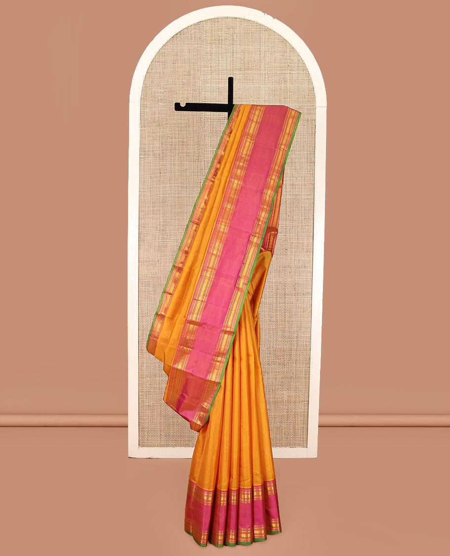 Orange Plain Kanchipuram Silk Saree, Complemented by Contrast Rettai Pettu Border of Rekku, Rudraksham, and Vanki Designs, Pallu of Traditional Zari Designs, and Paired with a Contrast Blouse