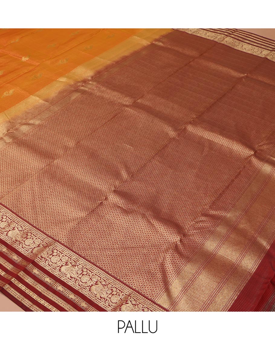 Orange Vasundhara Silk Saree, Masterfully Woven with Zari Buttas and Checks All Over Its Body, Complemented by a Contrast Border of Thilakam Mokku, Manga, Mayil, and Meen Designs, Grand Pallu, and Paired with a Contrast Blouse