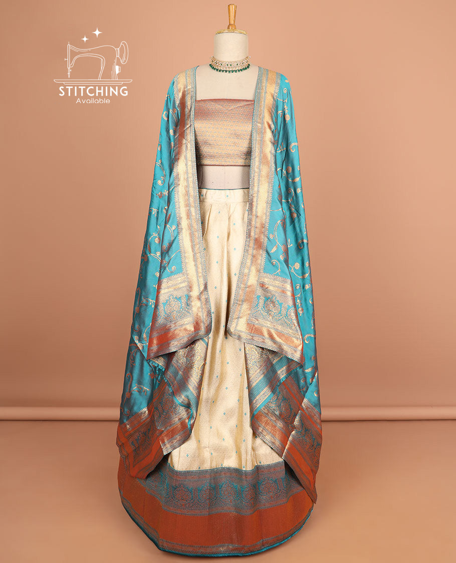 Cream motifs half saree with contrast zari design border, zari design blouse & blue floral vine zari design dhavani