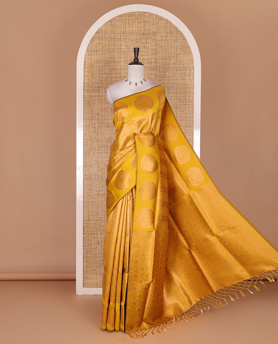 Yellow jacquard kanchi tissue saree, zari chakram motifs border, intricately zari woven pallu, and a matching zari design blouse