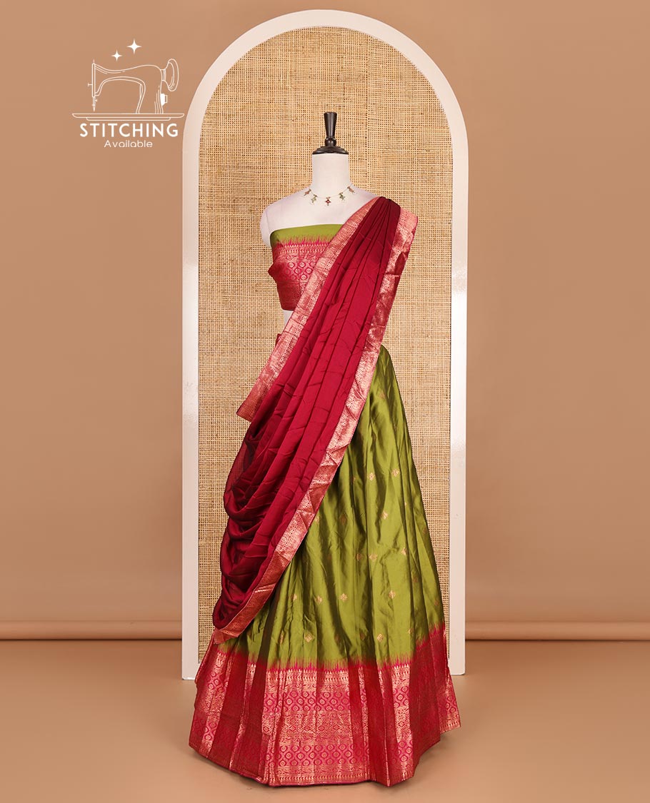 Green taffeta silk half saree, zari buttas with contrast red traditional zari border skirt, matching zari design blouse, and contrast plain zari border syska georgette dhavani