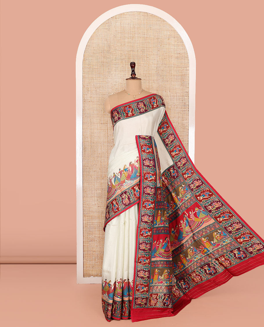 White Dola Silk Saree, Creatively Printed with Human Figurines on Its Body, Complemented by a Contrast Human Figurines Border, Pallu Depicts Colorful Human Figurines, and Paired with a Matching Blouse