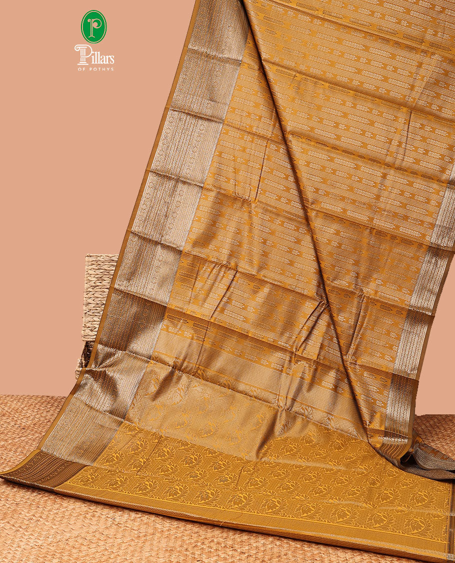 Mustard zig zag straight line leaf design elite silk saree, gold rose zari with veldari border , malli mokku design & rich pallu , rose gold brocade design blouse