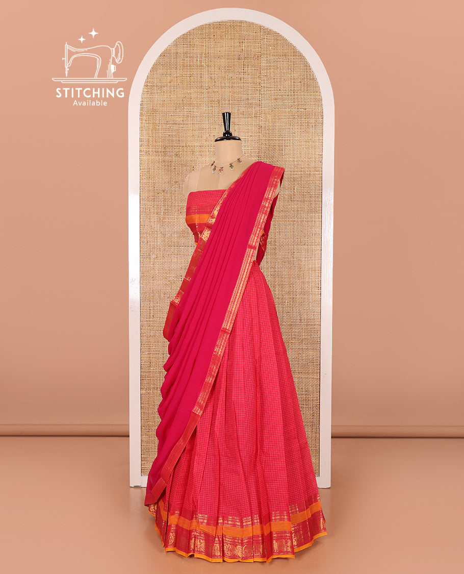 Rani Pink and Yellow Chettinad Cotton Half-Saree Featuring Checked Skirt, Highlighted with a Contrast Rettai Pettu Zari Peacock and Rudraksham Motifs Border, a Subtly Woven Matching Blouse, and a Georgette Traditional Zari-Bordered Dhavani