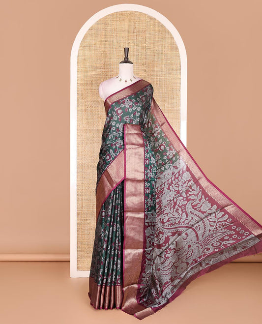 Green Kalamkari floral vine and peacock printed dola silk saree, contrast traditional zari border, peacock printed pallu, and floral vine print blouse
