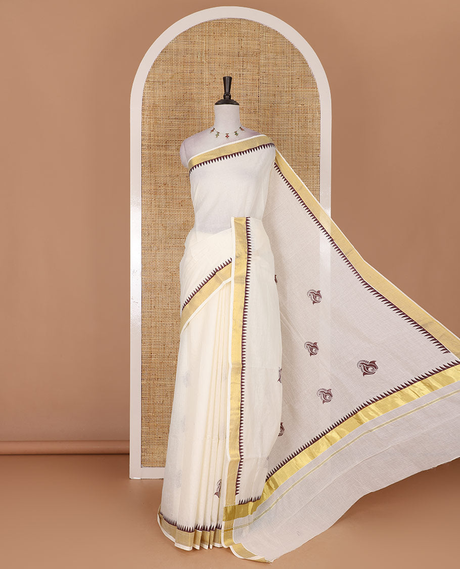 Half-white and maroon leaf motifs printed Kerala cotton saree, temple gold zari border, gold zari pallu, and matching blouse