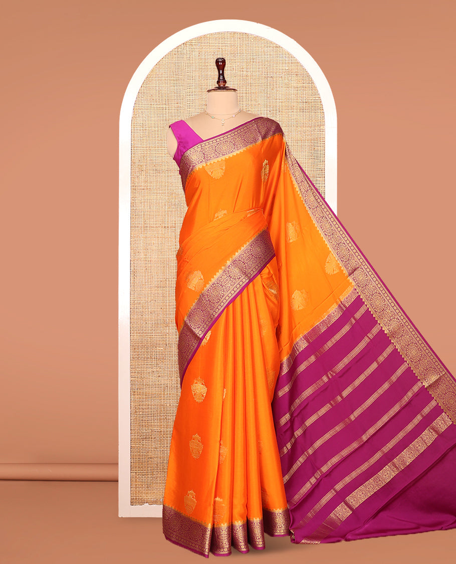 Orange Mysore Silk Saree, Bedecked with Zari Buttas All Over Its Body, Complemented by Captivating Contrast Border of Traditional Zari Designs, Gleaming Zari Striped Pallu, and Paired with a Contrast Blouse