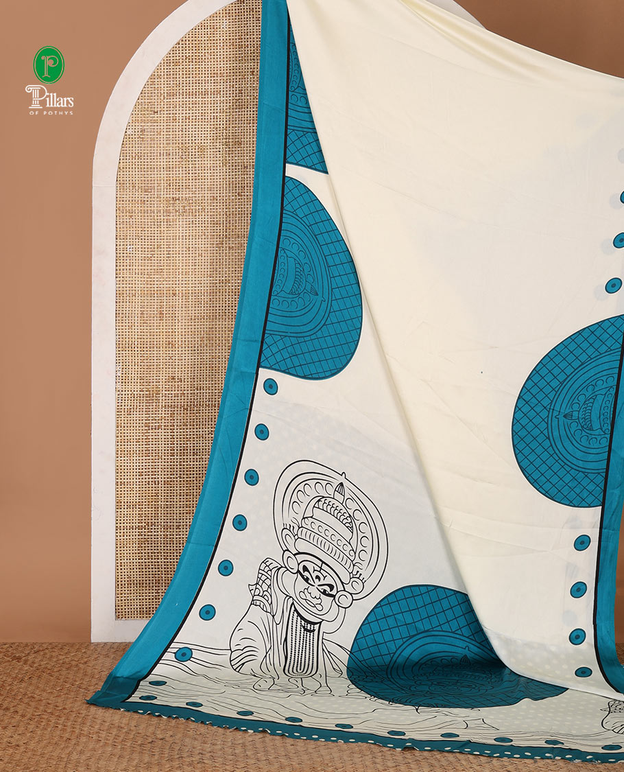 Cream printed semi-modal silk saree, contrast blue border of kathakali motif enclosed semi-circle, kathakali printed pallu & printed blouse