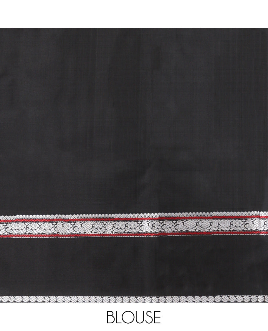 Black Kanchipuram Silk Saree, Delicately Woven with Buttas All Over Its Body, Highlighted by a Rettai Pettu Border of Thilakam Mokku, Neli, Mayil, and Manga Designs, Pallu Steeped with Stripes, and Paired with a Matching Blouse