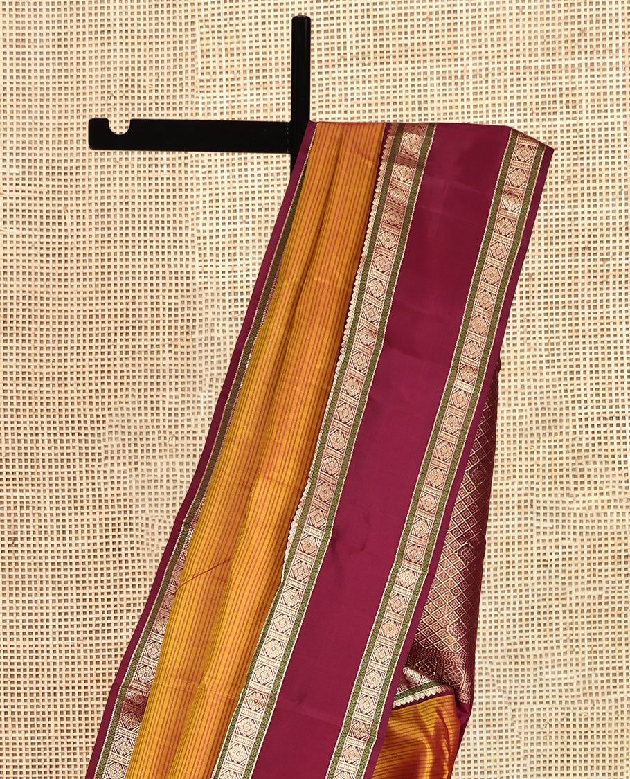 Mustard Striped Kanchipuram Silk Saree, a Contrast Rettai Pettu Border of Thilakam, Rudraksham, and Zari Designs, Intricate Pallu, and a Contrast Blouse