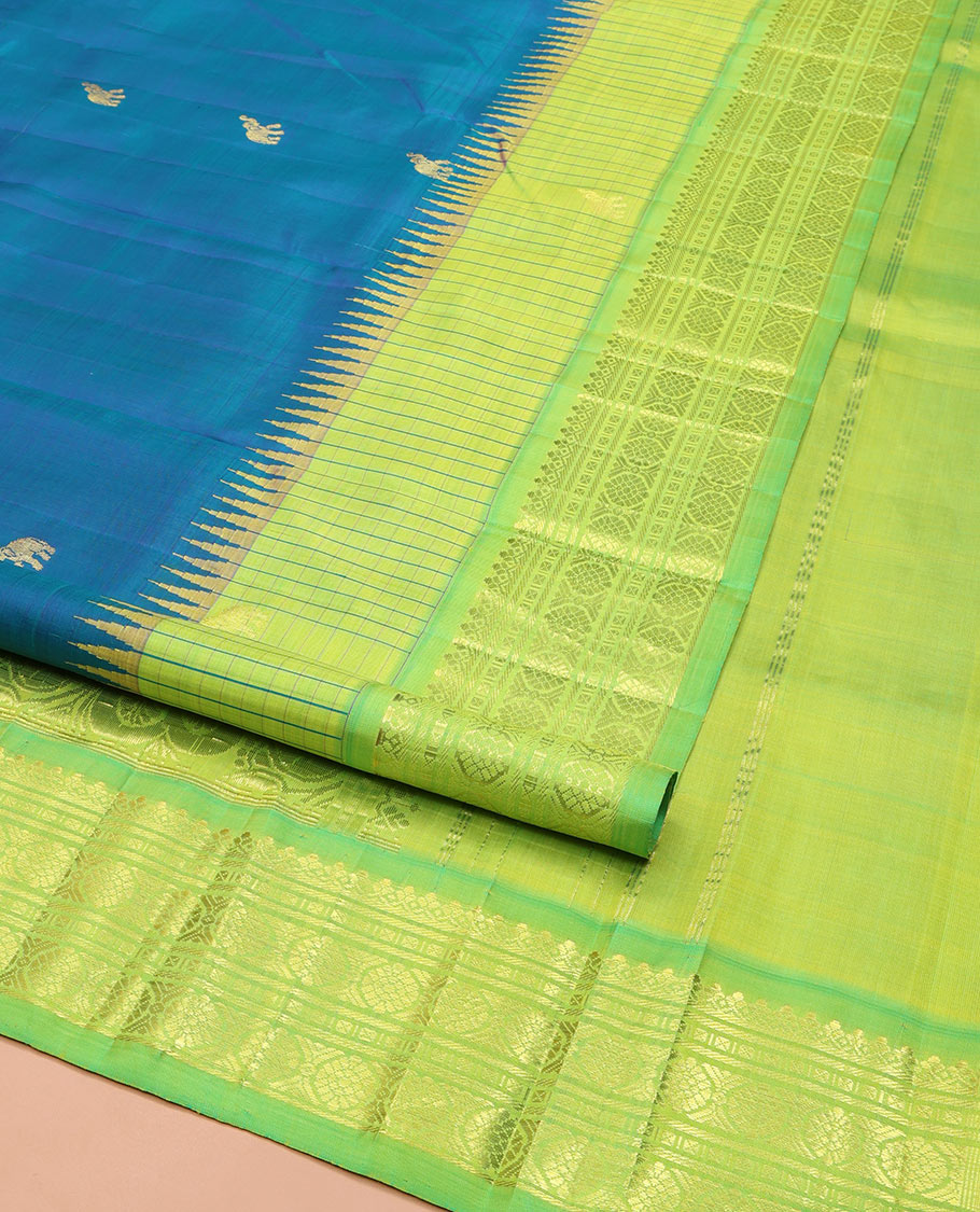Blue Kanchipuram Silk Saree, Bedecked with Yaanai Buttas, Complemented by Contrast One-Sided Checked Border of Thazanpoo Rekku, Salngai, Banaras, Lavangam, and Laddu Kamalam Designs, Pallu of Floral Designs, and Comes Without a Blouse