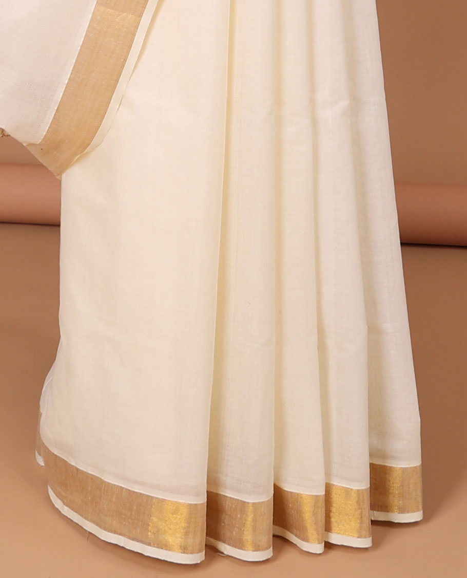 Cream kerala saree with zari designs, zari border & pallu of traditional designs in zari