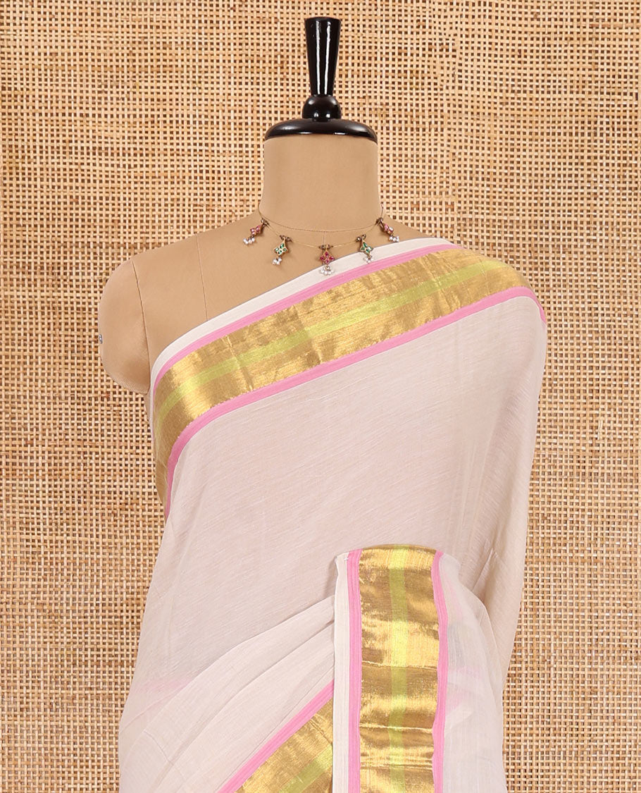 Cream Khadi mul cotton saree, contrast bavanji border, self-pallu with tassels, and a matching blouse