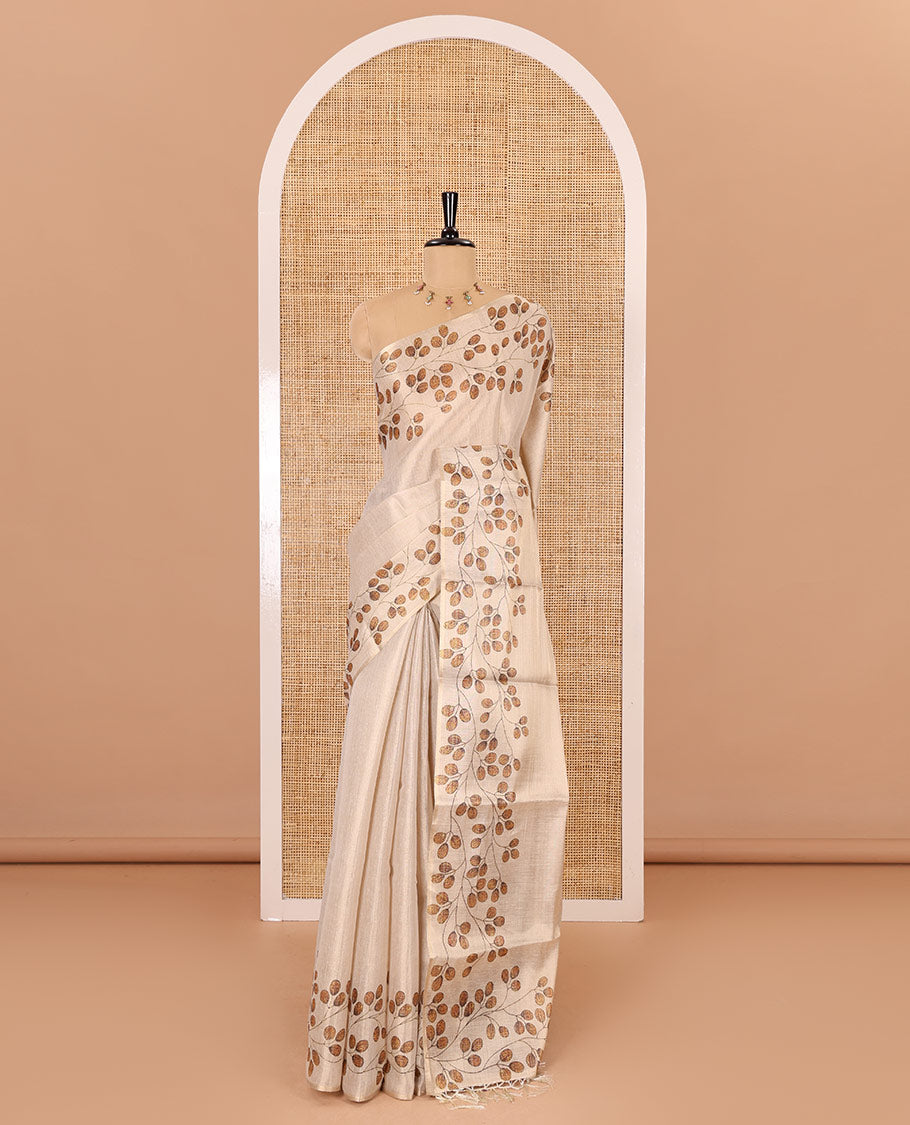 Cream plain body tissue saree with leaf vine printed border, printed pallu, and a contrast plain blouse